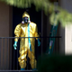 A hazardous-materials team member arrives Oct. 3, 2014, to clean a unit at the Ivy Apartments in Dallas where the confirmed Ebola virus patient Thomas Eric Duncan had been staying.
Joe Raedle